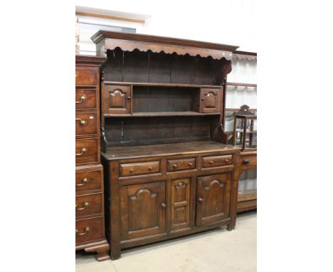 18th century Oak Welsh Dresser, the canopy back with moulded cornice above a shaped frieze, two shelves fitted with two small