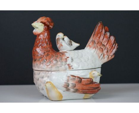 Ceramic hen on nest egg basket, modelled as a mother hen with attendant chicks, 18cm long 