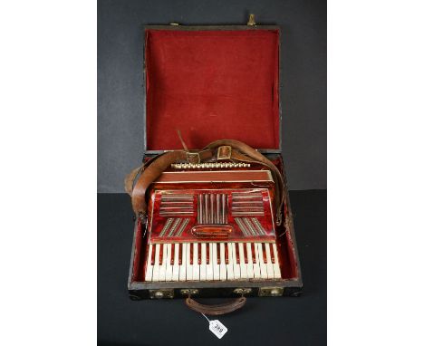 Mid 20th Century red piano accordion with leather strap, in wooden case (the accordion measures approximately 39cm wide, 36cm