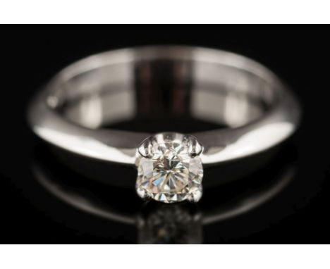 An 18ct white gold and diamond solitaire ring: the circular, brilliant-cut diamond estimated to weigh 0.35ct, in four claw se