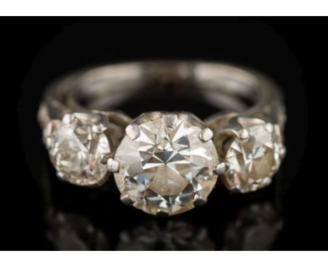 A diamond mounted three-stone ring: with round old European, brilliant-cut stones approximately 5.3mm x 3.3mm, 8.0mm x 4.8mm 