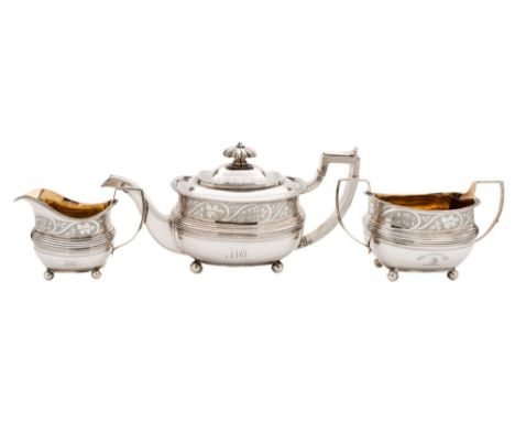 A George III silver three-piece tea service, maker's marks worn, London, 1814: crested, of barge shaped outline with banded f