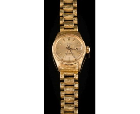 Rolex. A lady's 18ct gold wristwatch: the dial with baton markers and date aperture on a textured 18ct gold, President bracel