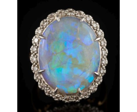 An 18ct gold, opal and diamond claw-set oval cluster ring: the oval opal 19.9mm long x 15.8mm wide x 5.8mm deep and within a 