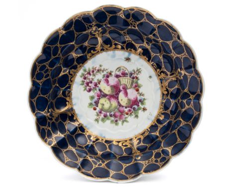 A First Period Worcester porcelain bowl: of scalloped and fluted form, the centre enamelled with a basket, apples and soft fr