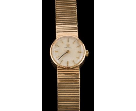 Omega. A lady's 9ct gold wristwatch: the circular dial with baton markers and on 9ct gold articulated strap, 29gms gross weig