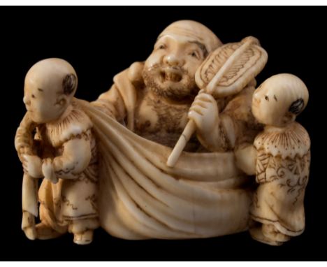 A Japanese carved ivory netsuke, signed Hidechika: of Hotei carried in his sack by three karako boys, 19th century, 2.5 x 3.5