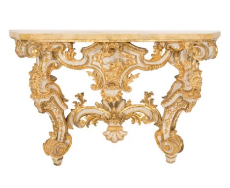 An Italian carved giltwood and decorated console table:, of serpentine outline in the Rococo taste, with a faux marble top, t