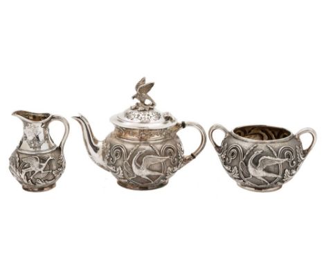 A Victorian silver three-piece bachelor's tea service, maker Walker & Hall, Sheffield, 1894: of circular form, with embossed 