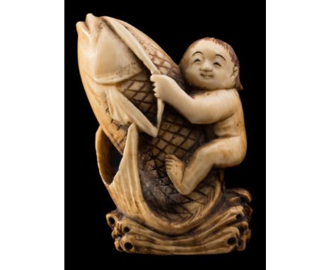 A Japanese carved ivory okimono and a netsuke: the first depicting Kinko riding on the back of a giant carp, 5.5 cm high; the