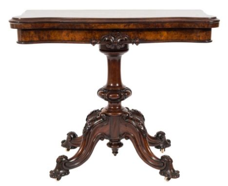 A Victorian carved walnut card table:, of serpentine outline, the burr veneered and baize lined hinged top with a moulded edg