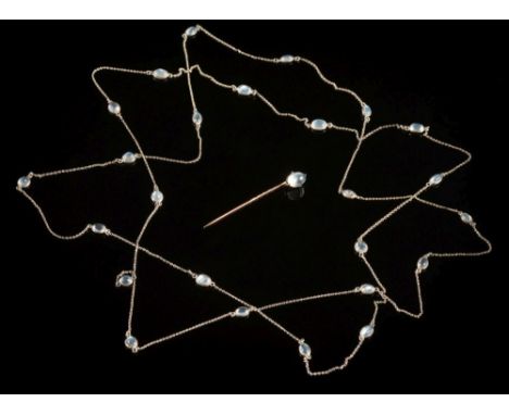 A silver and moonstone long chain necklace: of trace linking interspersed with round and oval moonstones in spectacle frame s