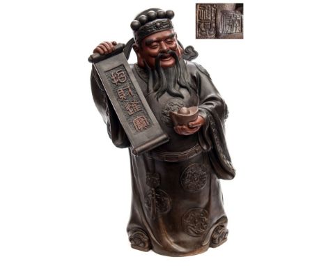 A Chinese Yixing figure of Lu: modelled standing in Mandarin's robes decorated with dragon medallions, holding a scroll in on