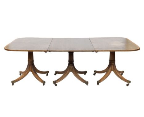 A mahogany and inlaid three pillar dining table in the Regency taste:, the snap tops with a satinwood and boxwood and ebony s