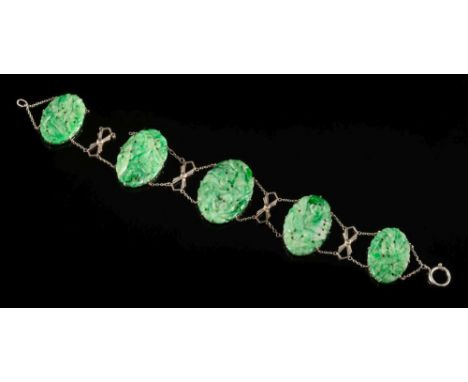 A carved and pierced jade oval panel-link bracelet: the largest panel 30mm long x 20mm wide and on bolt ring clasp, some dama
