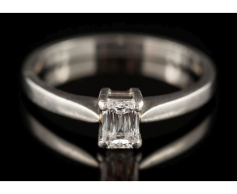 A platinum and baguette-cut diamond solitaire ring: the baguette-cut diamond 4.9mm long x 3.5mm wide x 2.5mm deep, estimated 