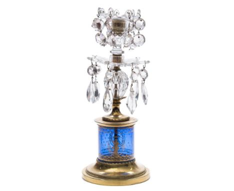 A Regency cut-glass and brass candlestick: the blue glass column gilded with classical figures within ovals, the nozzle and d