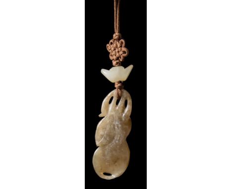 A Chinese carved and pierced agate pendant: in the form of a monkey and a beetle amongst a gourd, foliage and lingzhi fungus,