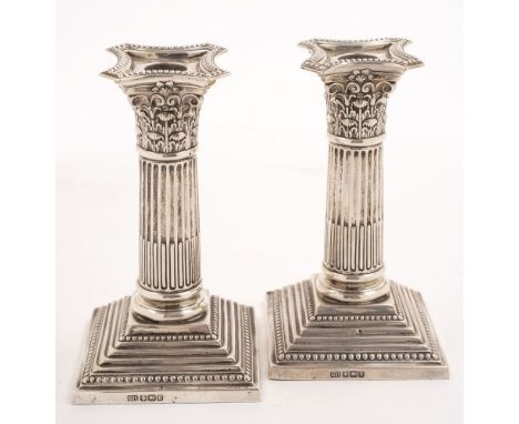 A pair of George V silver Corinthian column desk candlesticks, maker Harrison Brothers and Howson, Sheffield, 1913: with bead