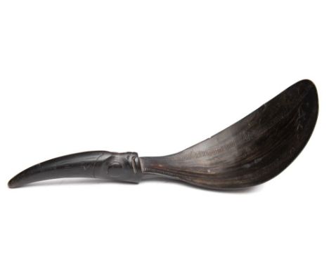 A North West coast native American carved horn spoon: the pear-shaped bowl with two serrated lines of decoration to the inner