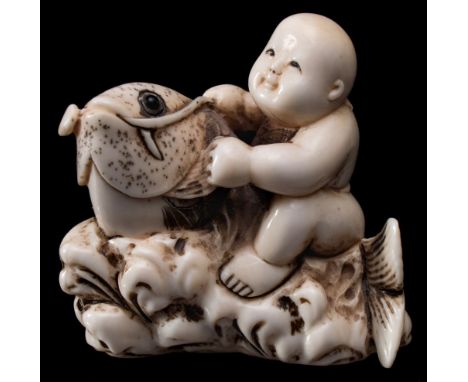 A Japanese carved  ivory netsuke, signed Shugetsu : in the form of Kintaro [Golden Boy] riding on the back of a giant carp, l