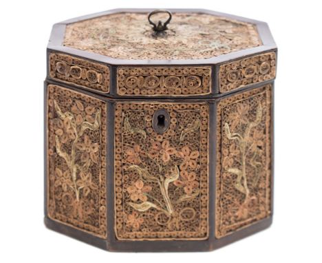 A George III mahogany and quillwork tea caddy: of octagonal outline, the hinged lid and sides decorated with quilling decorat