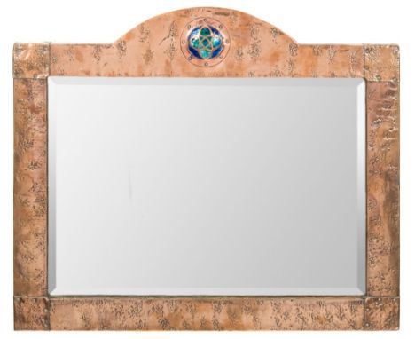 An Arts and Crafts copper and enamel wall mirror: the rectangular mirror plate enclosed within an arched frame with circular 