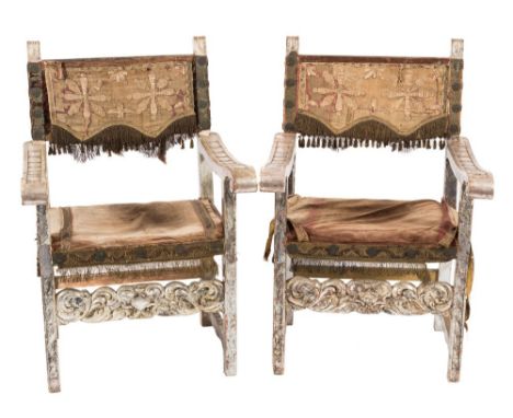 A pair of Italian carved and silvered wood open armchairs:, in the 17th Century taste, the backs with needlework and wire thr