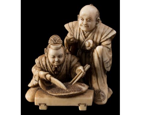 A Japanese carved ivory netsuke, signed Ryomin: in the form of a seated man ceremoniously carving a large fish, a smiling sam