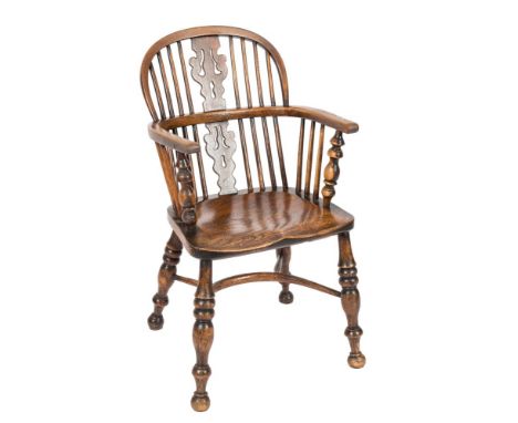 A 19th Century elm, ash and beechwood stick back Windsor elbow chair:, the arched back with a pierced central splat, the arm 