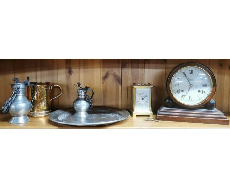 An early pewter plate and a brass tankard with two further pewter items, a mantle clock and a brass carriage clock.