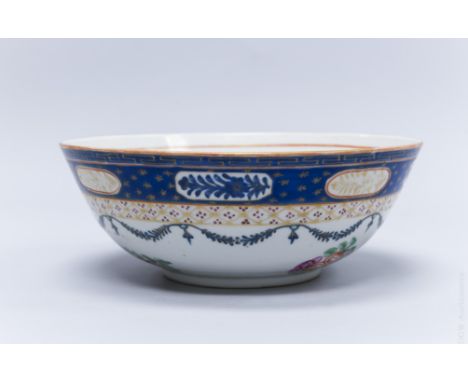 Chinese export porcelain famille rose bowl. Hand enamel and parcel gilt blue band border with reserves and garlands and flora