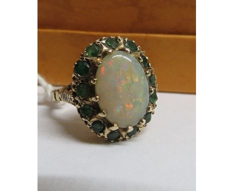 A yellow, gold opal and emerald cluster ring