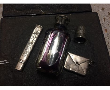 A Victorian amethyst and crystal overlaid and silver glass scent bottle with silver cap, a silver envelope stamp case, a silv