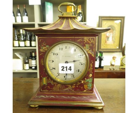 Circa 1900 a Japanned mantle clock having a brass carrying handle and a Swiss made 8 day movement