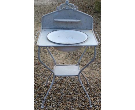 Early C20th metal washstand with splash back and floral design, complete with enamel bowl, H110cm W65cm 