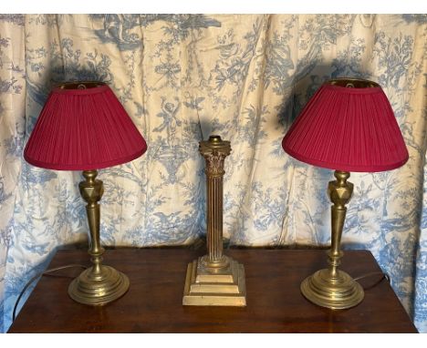 Pair of C20th brass table lamps, tapering columns with lozenge knop on stepped circular bases with pleated cranberry shades H