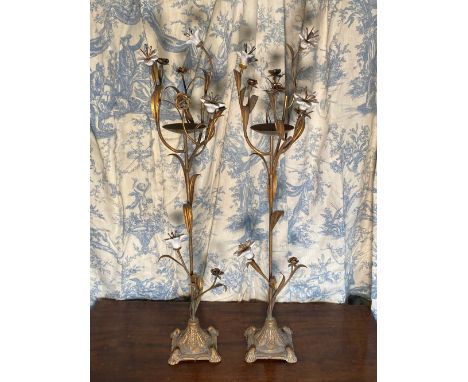 Pair of gilt metal and ceramic pricket candle sticks with white flowerheads on slender naturalistic support with  stepped dom