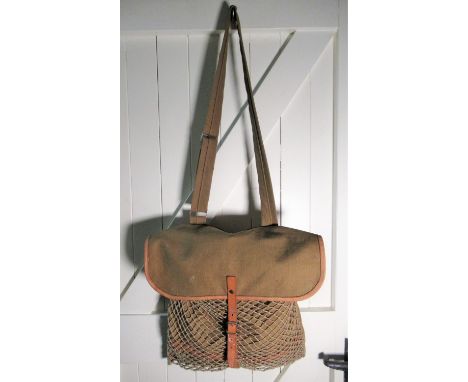 Leather trimmed green canvas game bag containing game net, a wooden and antler handled skinning knife, a Leatherman multitool