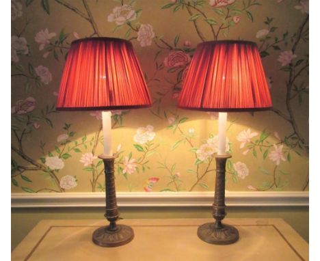 Pair of Recency style cast brass candlestick table lamps, with urn sconces and wrythen cast stems on circular acanthus bases 