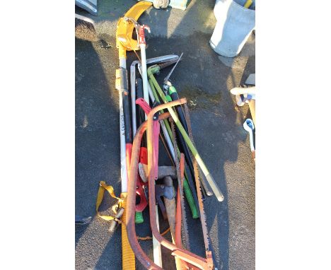 Collection of tools relating to tree work including cross cut saws, long handled pruners, log splitting axes, hand saw in cas