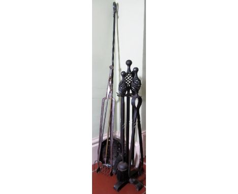 Set of four craftsman made steel fire tools with pierced finials, on stand, a similar chestnut roaster, a set of vintage poli