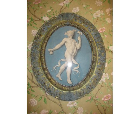 After the Antique - Jasper style print of a Roman god, with winged helmet and ribbon tied staff in moulded gilt frame, oval, 