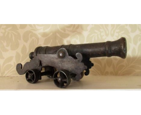 C20th cast metal model of a signal cannon, ribbed barrel on shaped carriage and spoked wheels, L23cm 