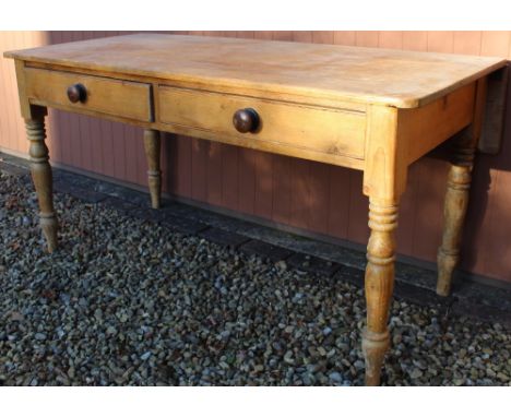 Victorian pine kitchen table, rectangular rounded top with fall leaf above two drawers with turned wooden handles, on ring tu