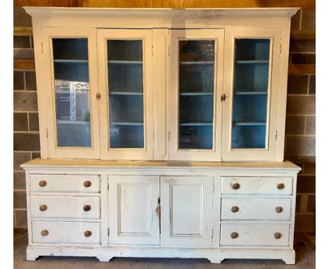 Large later painted Victorian pine dresser, moulded cornice above four glazed doors with shelves, projecting base with two ce