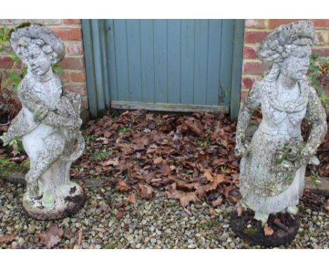 Pair of Victorian style weathered composite garden figures in the form of male and female gardeners with flower baskets, on c