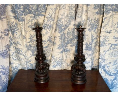 Pair of Indian bronze table lamps, the pierced columns cast with dragons on triple elephant support, stepped circular bases H