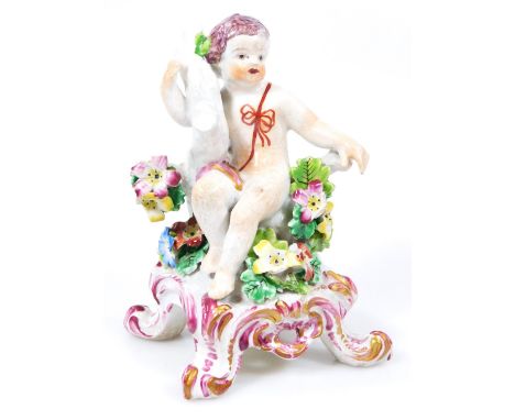 A Bow figure of a Putto, raised on a 'C' scroll base, c.1760, unmarked 12cm high.