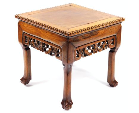 A Chinese late Qing period lamp table, the square top with beaded outline on wide crossbanding raised above a carved floral f